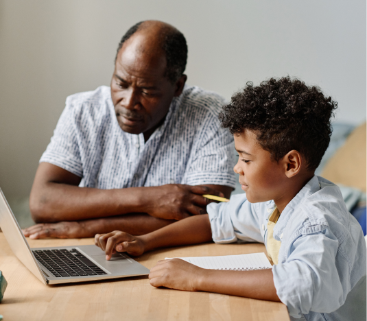 Black male tutoring a boy with a laptop and text for 5th grade common core math overview on the right