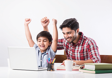 A Man and his Boy are Cheering in Fron of a Laptop