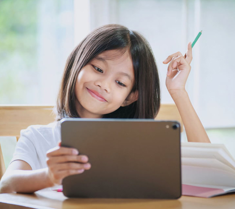 A Girl Taking Notes from her Tablet Device in other Hand